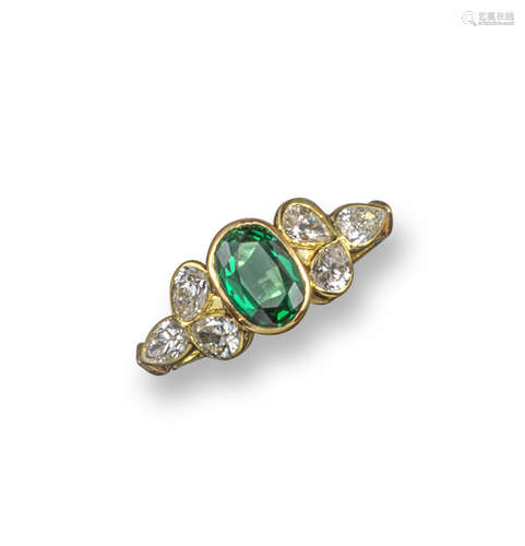 An emerald and diamond cluster ring