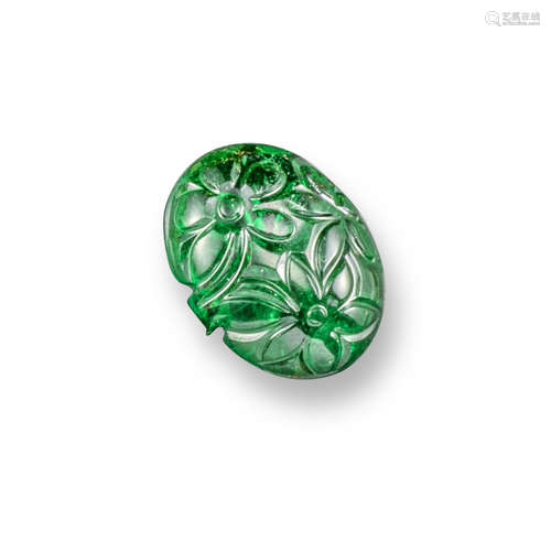 A carved emerald bead