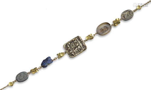 A gold necklace mounted with five assorted carved gems of various dates