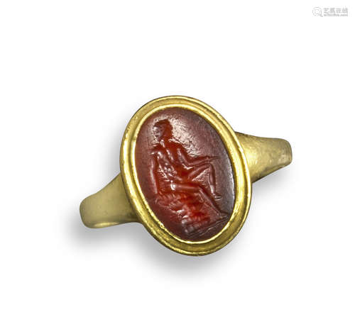 A Roman carnelian intaglio depicting a seated Apollo