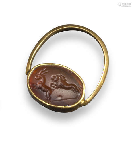 A Hellenistic carnelian intaglio depicting a lion chasing a gazelle