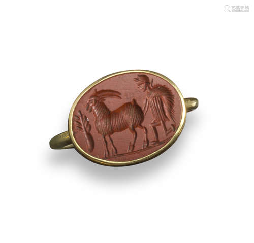 A Roman red jasper intaglio depicting a shepherd tending to a goat