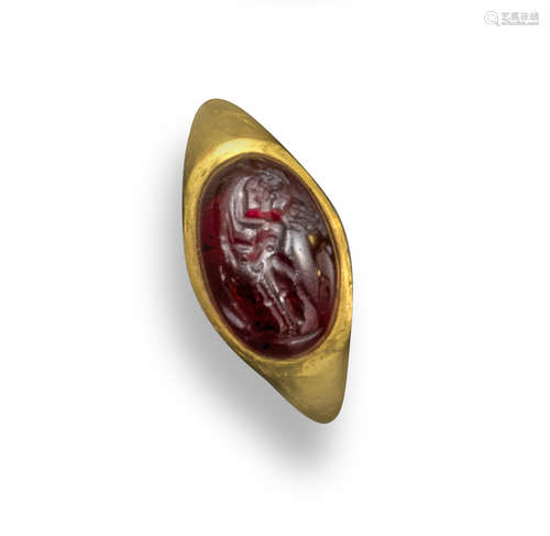 A Roman domed garnet intaglio depicting Cupid