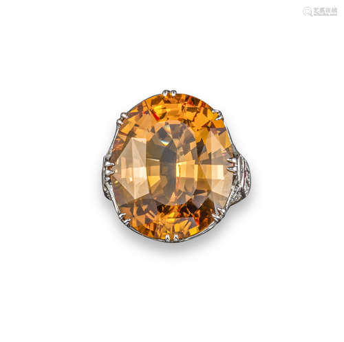 An orange topaz and diamond ring