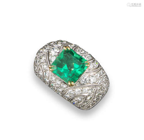 An emerald and diamond bombé ring