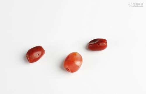 A Group of Three Antique Red Agate Beads