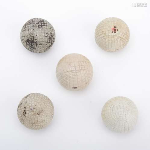 A group of five golf balls