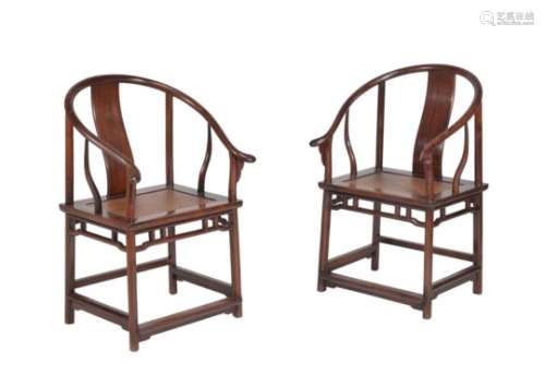 A pair of Chinese hardwood horseshoe-back armchairs