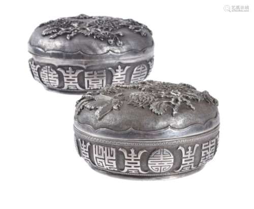 A pair of Chinese export silver 'longevity' circular boxes and covers
