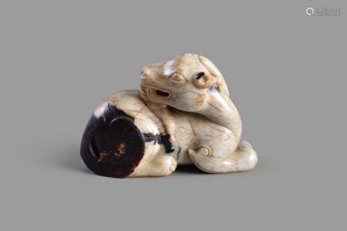 A Chinese white and dark brown jade figure of a mythical beast