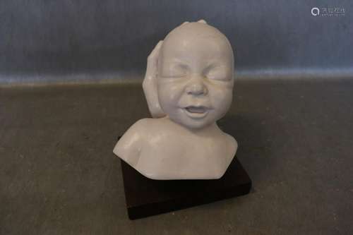 Carved Child Bust in Hand, Signed TL 1979