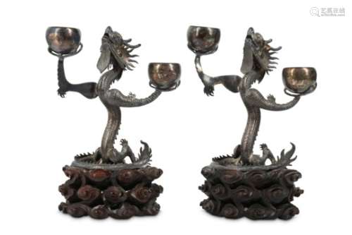 TWO CHINESE SILVER 'DRAGON' CANDLE STICKS.