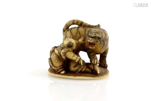 A stained ivory netsuke on oval base with single himotoshi, carved as the boy hero, Yoko and the