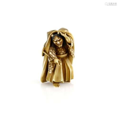 A small lacquered ivory okimono of a Noh, or other theatre, performer in the role of Hannya;