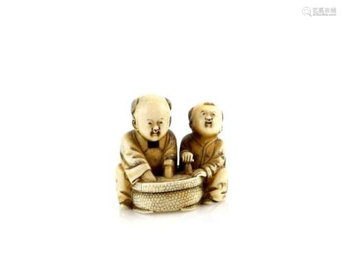 An ivory netsuke of two boys beside a circular tub of water, signed HominProvenance: The Property of