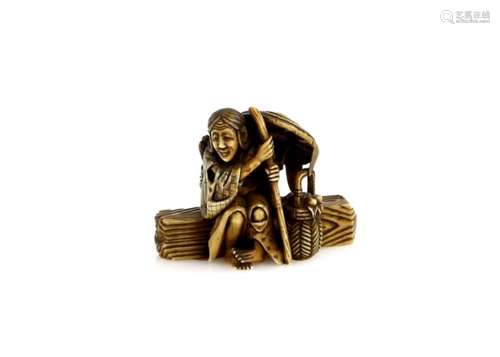 A stained ivory netsuke of the Heian waka poetess, Ono no Komachi (circa 825-900), seated on a log