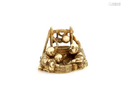 A stained ivory netsuke of a man and two boys around a tub, 19th CenturyProvenance: The Property