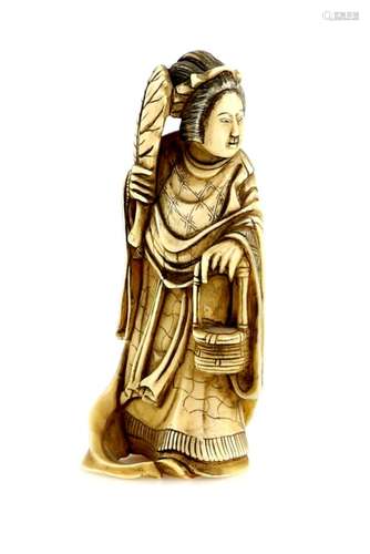 A small ivory okimono, carved as Seiobo, holding a fan in her right hand and a basket in her left