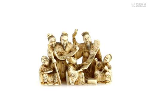 A stained ivory netsuke or small okimono carved as Seven Scholars reviewing two makemono, signed