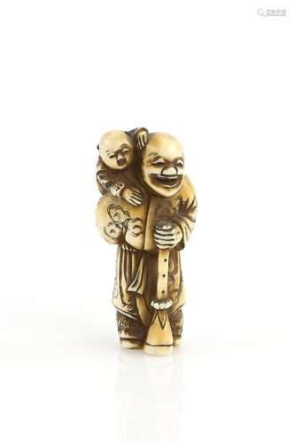 An ivory netsuke of a Dutchman, or other Gaijin, holding a long horn and carrying a child, signed