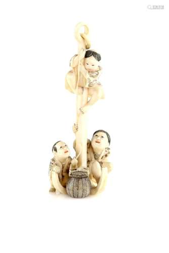 A stained ivory okimono of three boys beside a large anchor, 12 cm high, 20th CenturyProvenance: The