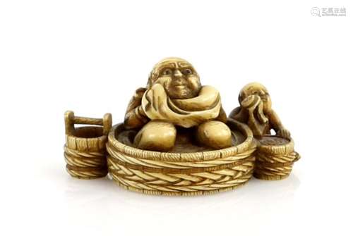 A stained ivory netsuke carved as Hotei kneeling in a large circular tub beside a boy washing his