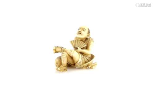 A stained ivory netsuke of a traveller seated on a bundle, and holding a fan with his left hand; the