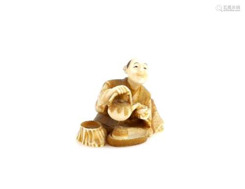 A heavily stained ivory netsuke of a man with a dobin pouring tea into a chawan, signed Kozan,