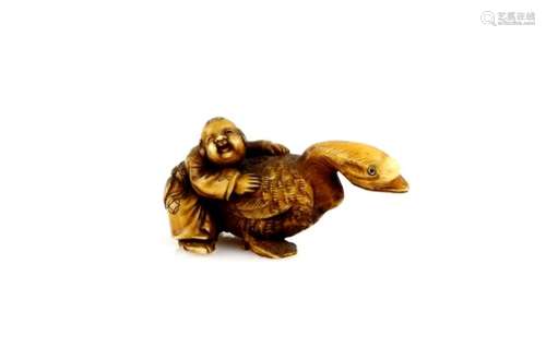 A stained ivory netsuke of a boy holding a massive goose, 20th CenturyProvenance: The Property of