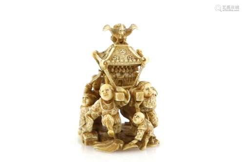 An okimono style netsuke with single himotoshi, carved as a crowd of boys carrying a large Shinto or