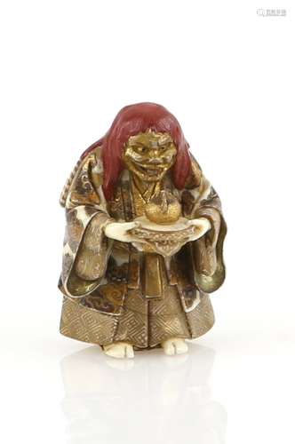 A lacquered ivory netsuke of a red-haired actor, holding a jewel, 20th CenturyProvenance: The