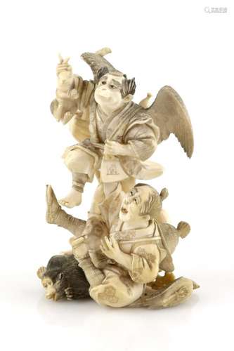 A stained ivory okimono, carved as a Tengu holding up a rabbit and frightening a hunter with his