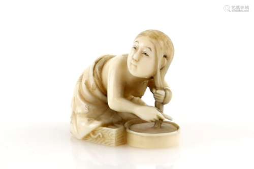 A stained ivory netsuke carved as a girl washing her hair, signed Soshu, 20th CenturyProvenance: The