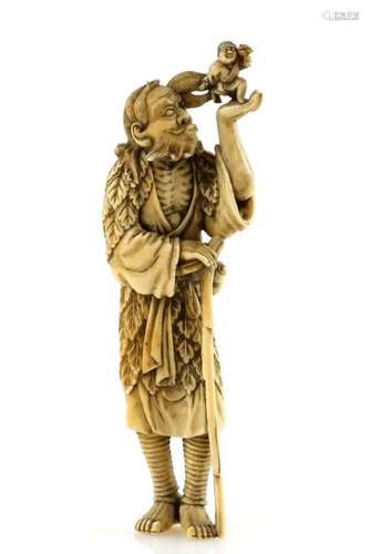 A stained ivory netsuke of Tekkai Sennin with a gourd flask at his waist and holding a crutch with