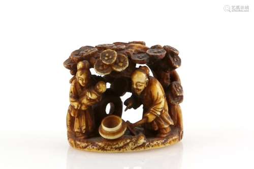 A stained ivory netsuke with central himotoshi on the base carved as the story of Hanasaka Jiji (The