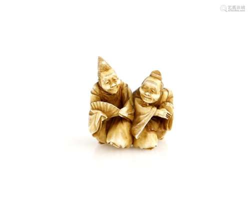 A stained ivory netsuke carved as a pair of Manzai Dancers, 19th or 20th CenturyProvenance: The