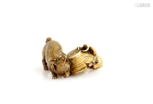 A small stained ivory okimono of a cat finding an octopus beneath an upturned bowl, signed Masaka,