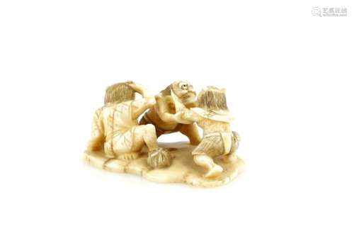 A large ivory netsuke with central himotoshi, carved as three Oni fighting, about 5 cm wide, 19th or