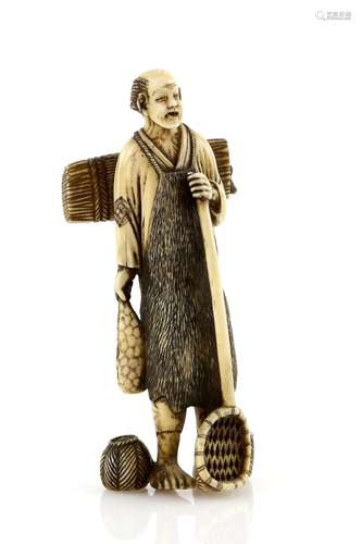 A heavily stained ivory okimono carved as a standing farmer, holding a net with his left hand and