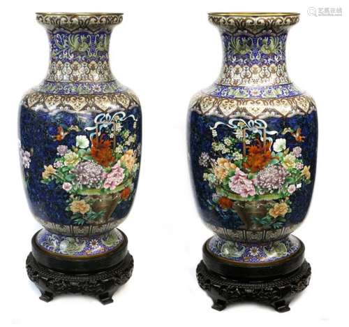 A large and impressive pair of cloisonne enamel vases; each one with flaring trumpet neck and