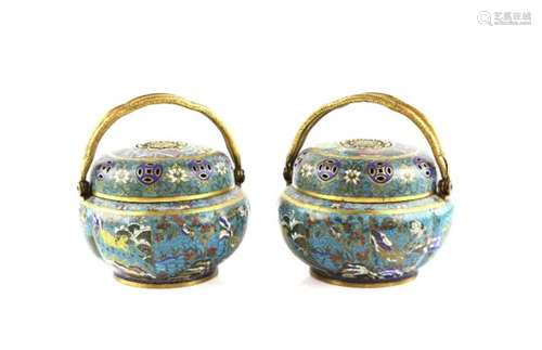 An elegant pair of Chinese cloisonne enamel incense burners; each one with hinged gilt handles,