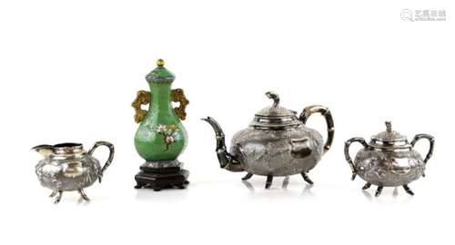 A Chinese silver part tea service, comprising: a teapot with hinged domed cover decorated with a