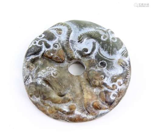 Chinese green/brown jade disc carved with bats to one side, interlocking scrolling decoration to the