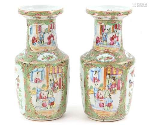 A pair of Canton famille rose vases, decorated with typical panels of narrative scenes, birds and