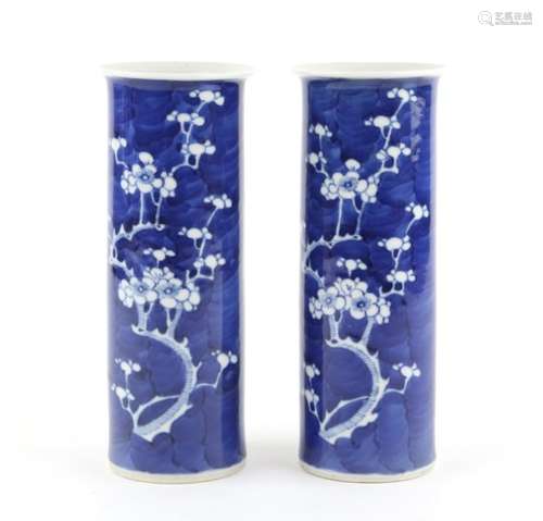 A pair of Chinese blue and white cylindrical vases decorated with prunus blossoms, 20.5cm high;