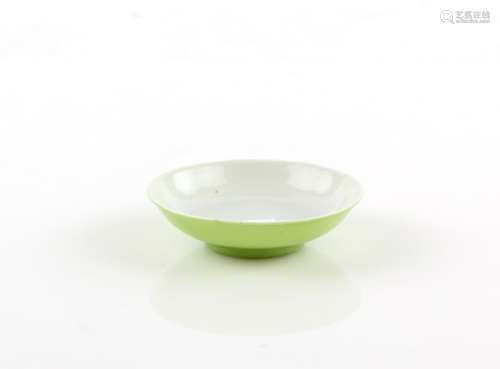 A small lime-green monochrome saucer dish; the base with underglaze blue Jiaqing six-character mark,