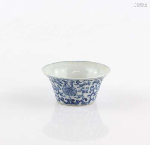 A blue and white bowl with flaring rim, decorated on the exterior with flower heads and scrolling