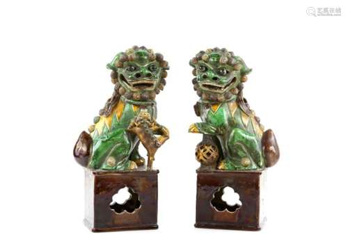 A pair of susancai glazed figures; each one of a seated Buddhistic Lion, 35 cm high, post Qing