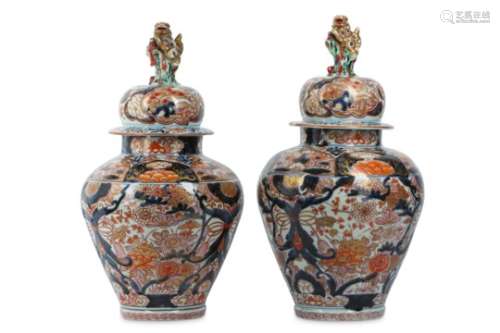 A PAIR OF IMARI VASES AND COVERS. Circa 1700. Each decorated in iron-red and gilt on underglaze blue