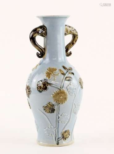 A lavender blue ground vase with floral design and elephant head handles; the base with underglaze